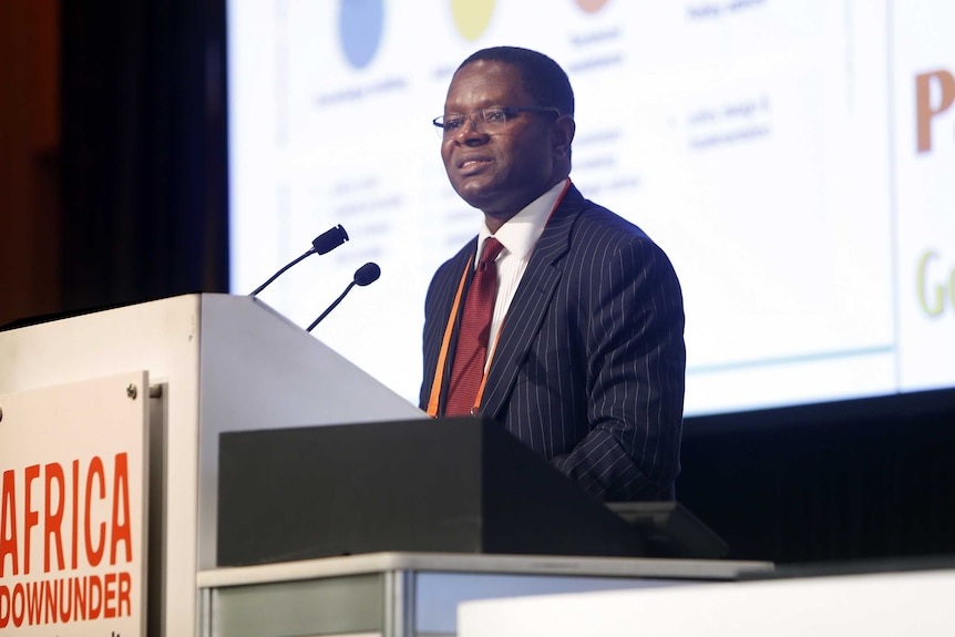 Kevin Urama, African Development Bank advise, at a podium addressing delegates at the Paydirt Media Africa Down Under Conference