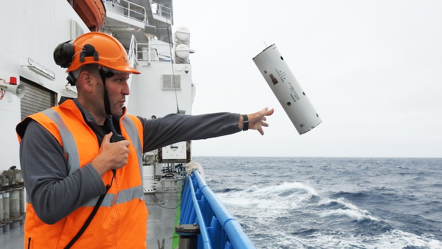 Brian Miller deploying a sonobuoy listening device off the Investigator near Antarctica