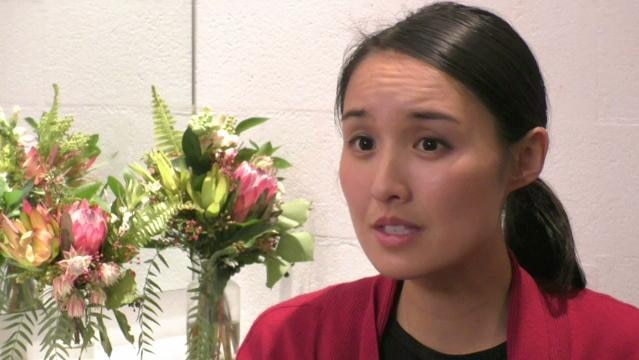 Author Alice Pung sits beside flowers