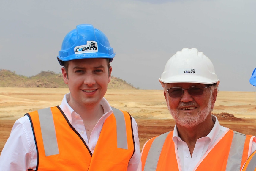 CuDECO chair David Taylor and managing director Peter Hutchinson standing on a mine site with hard hats on.