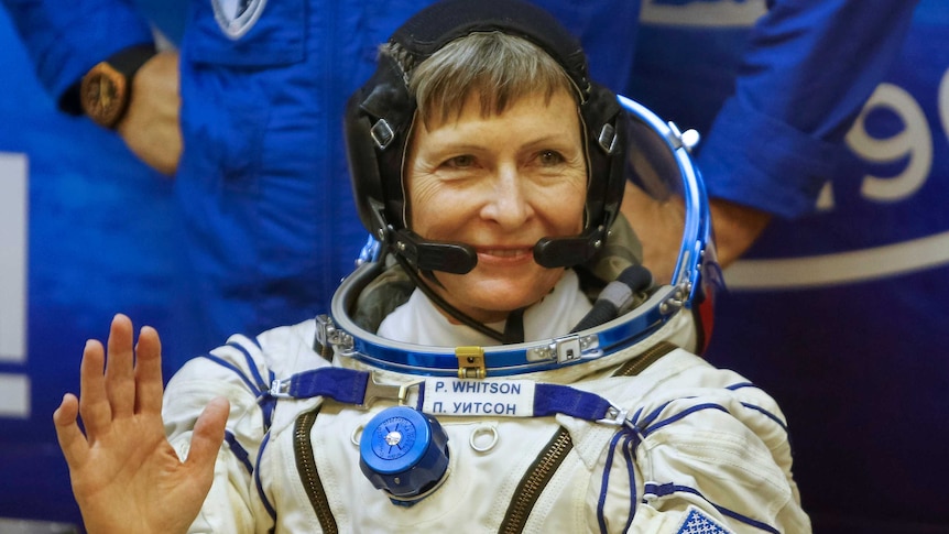 Astronaut Peggy Whitson waves.