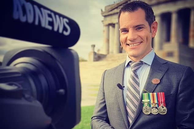 Man wearing medals on chest standing in front of a news camera with the Shrine in the background.