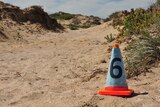 Orange cone marks the campsite in sand dunes were two backpackers were attacked.