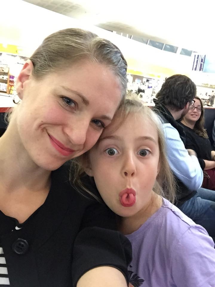 A woman and daughter make faces at the camera.