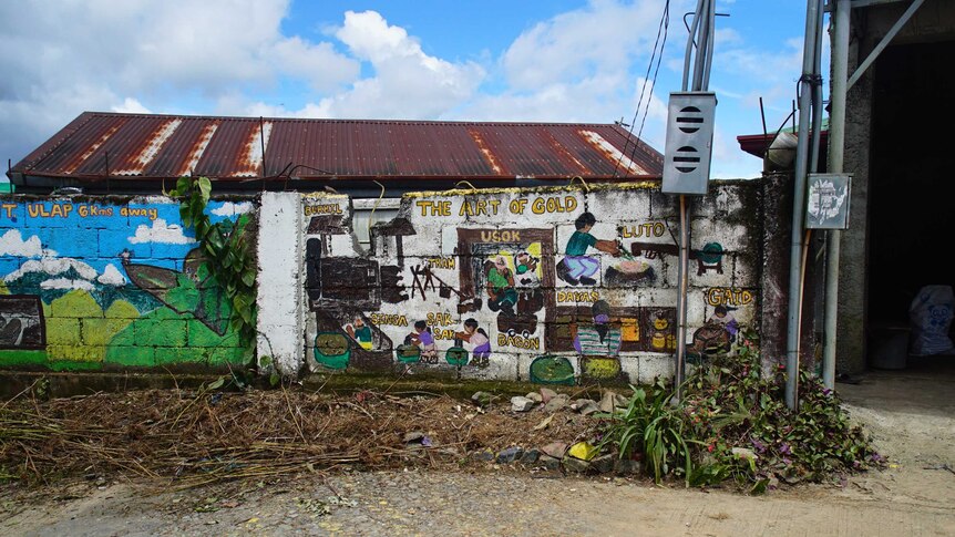 A mural pays tribute to the importance of gold in Itogon, Philippines.