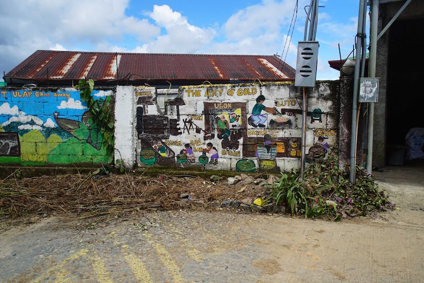 A mural pays tribute to the importance of gold in Itogon, Philippines.