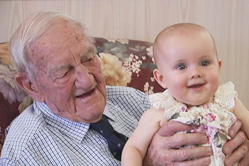 Chuck Younger holds his great granddaughter.