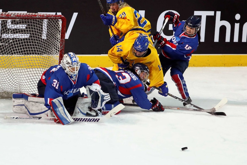 Inter-Korea's Park Yoon-jung and Sweden's Sabina Kuller in action in an ice hockey friendly.