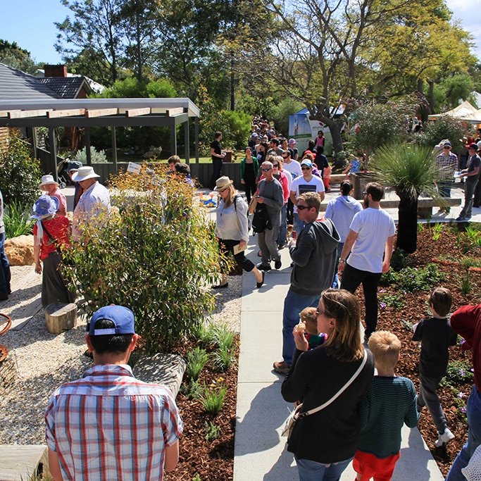 People walk around the garden at at Open Day at Josh's House in Fremantle Western Australia