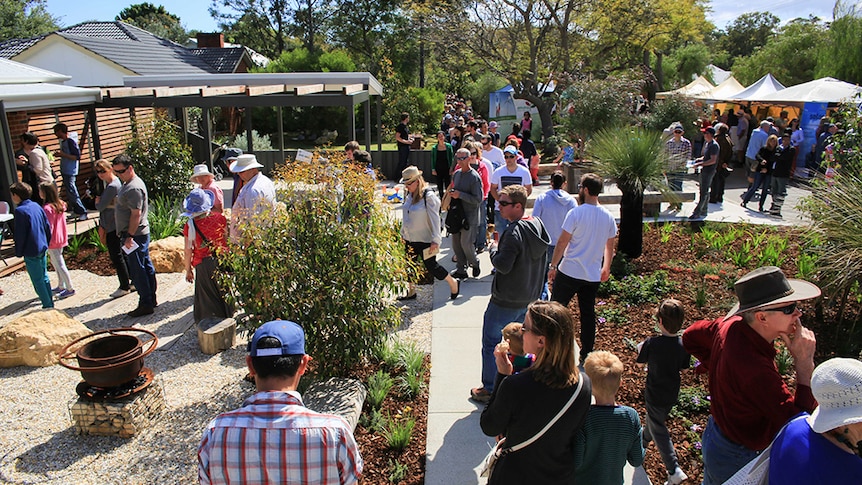 People walk around the garden at at Open Day at Josh's House in Fremantle Western Australia