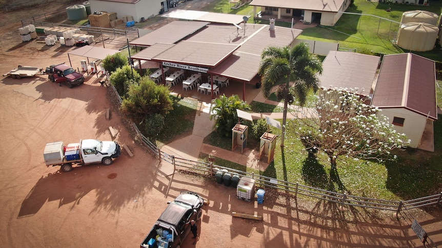 aerial picture of remote roadhouse with 4WDs parked out front