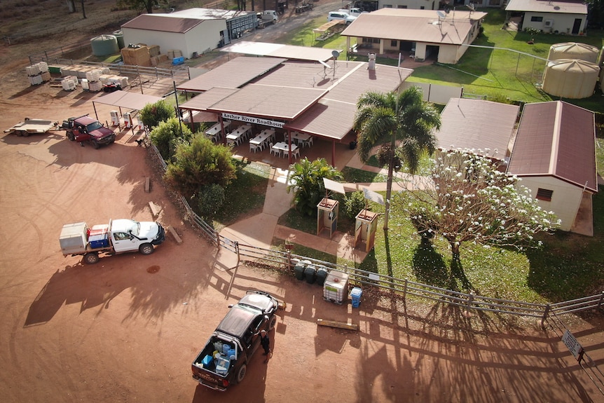 aerial picture of remote roadhouse with 4WDs parked out front