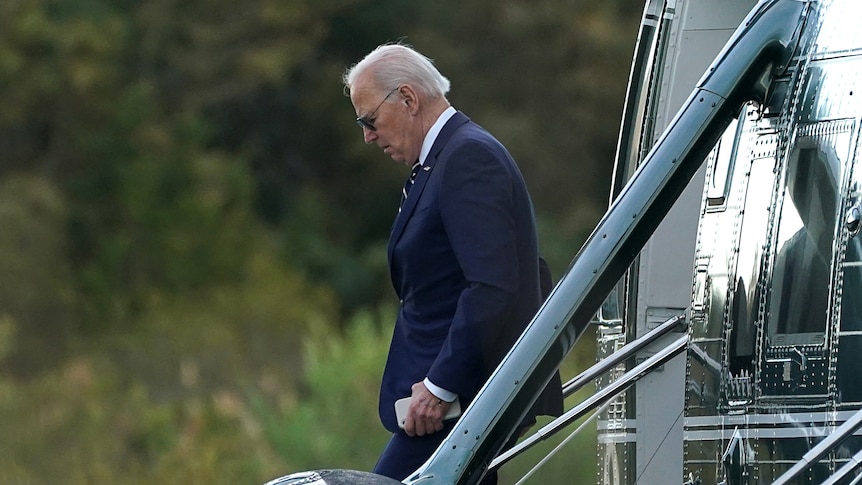 Joe Biden is pictured from the side as he leaves his Marine One aircraft.