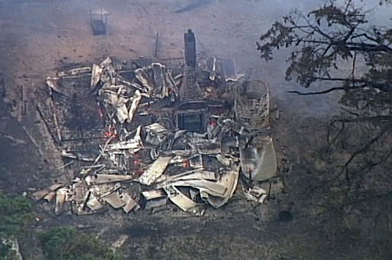 A chimney standing in the ruins of a building destroyed by the Bunkers Hill fire.