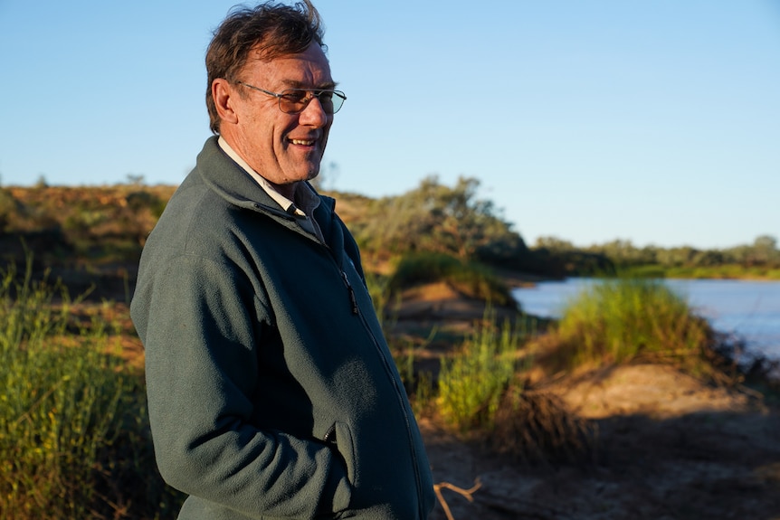 Ranger Chris Mitchell stands in front of one of the Diamantina lakes which are full of the floodwater from Feb/March.