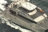 Police boat searches for the missing plane.