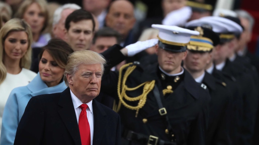 US President Donald Trump stands with members of the military at his inauguration ceremony.