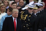 US President Donald Trump stands with members of the military at his inauguration ceremony.