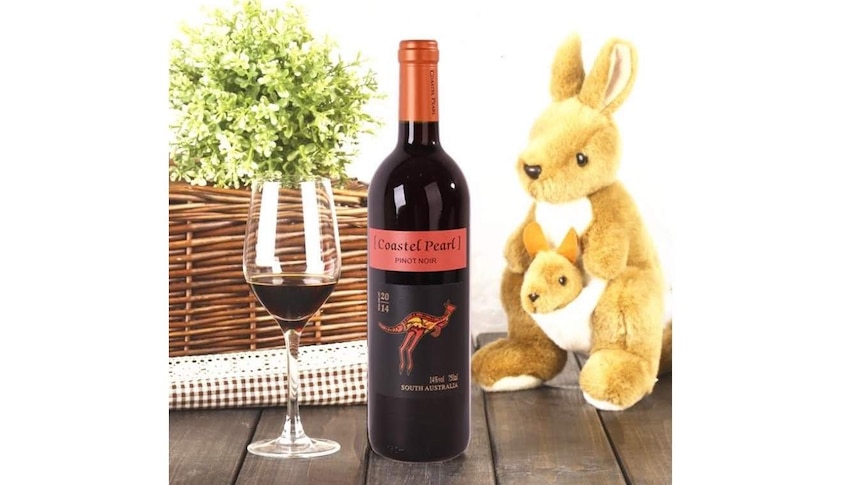 'Coastel Pearl' wine on Pinduoduo with a stuffed kangaroo. The label looks like Yellow Tails wine from Australia.