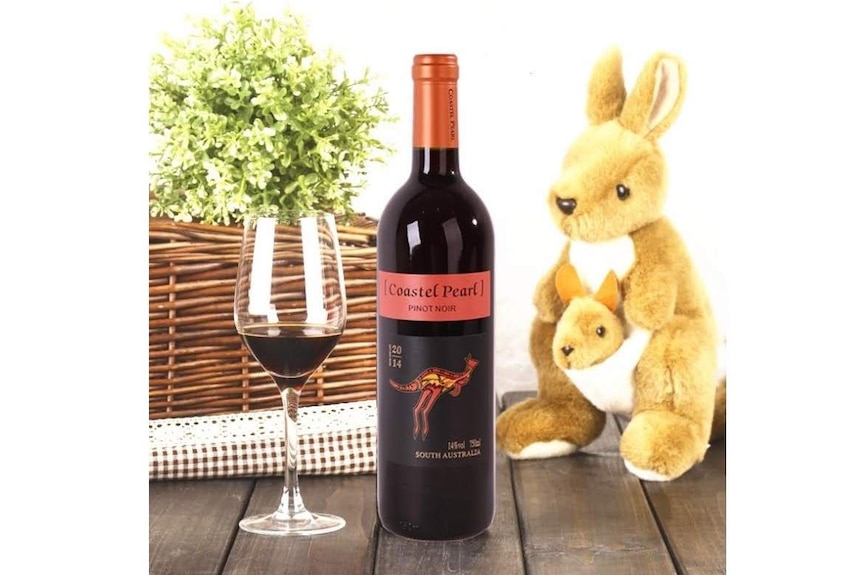 'Coastel Pearl' wine on Pinduoduo with a stuffed kangaroo. The label looks like Yellow Tails wine from Australia.