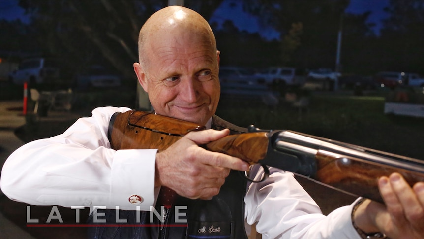 Senator David Leyonhjelm aiming a shotgun on Lateline, October 20, 2016.