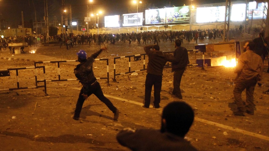 Pro and anti-Morsi demonstrators clash on the road leading to the Egyptian presidential palace.