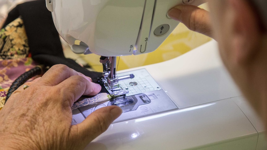 Hands on a sewing machine