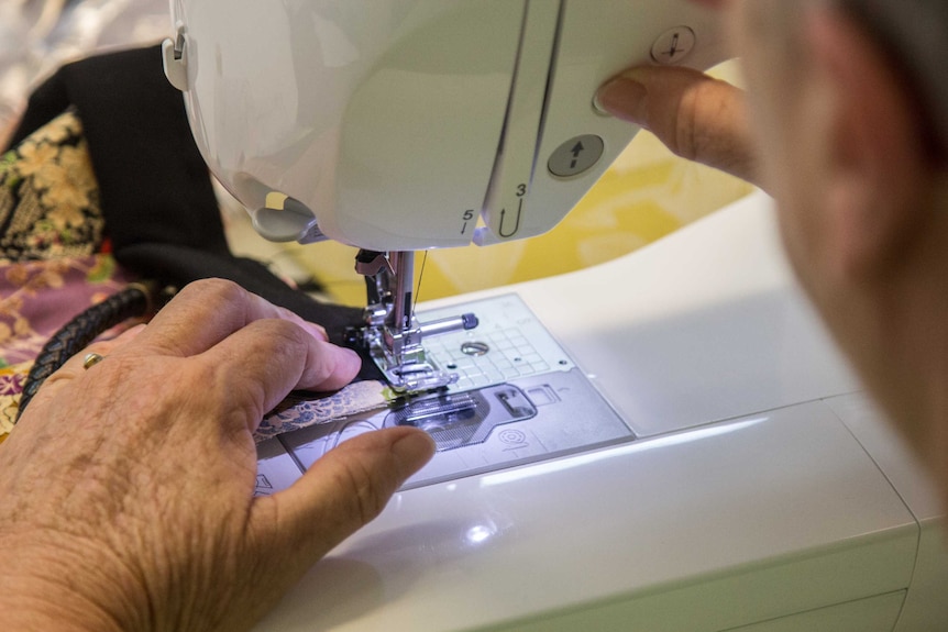 Hands on a sewing machine