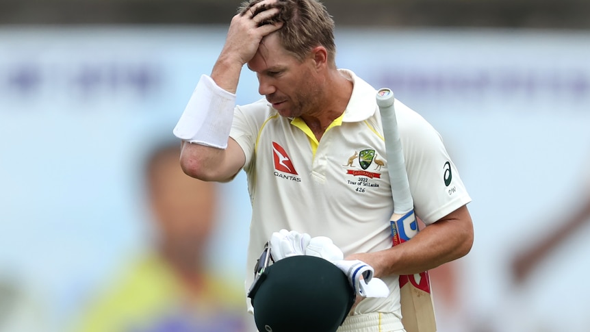 A man leaves the pitch after being dismissed in a test match