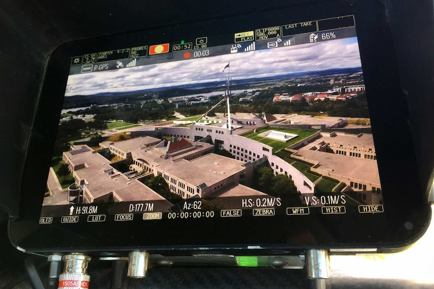View on screen of aerial shot of Parliament House taken by drone during filming of The House with Annabel Crabb.