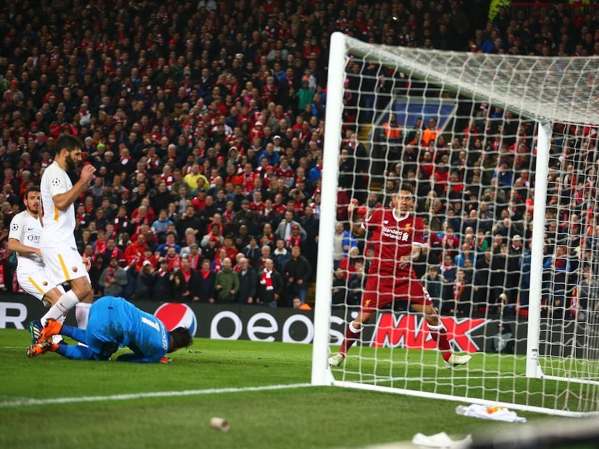 Liverpool's Roberto Firmino, right, scores his side's fourth goal during soccer match between Liverpool and AS Roma.