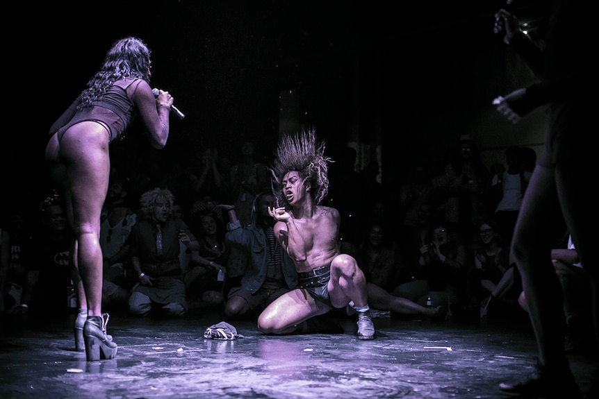 Colour photo of artist KoCo Carey performing during a voguing battle at Day for Night 2018.