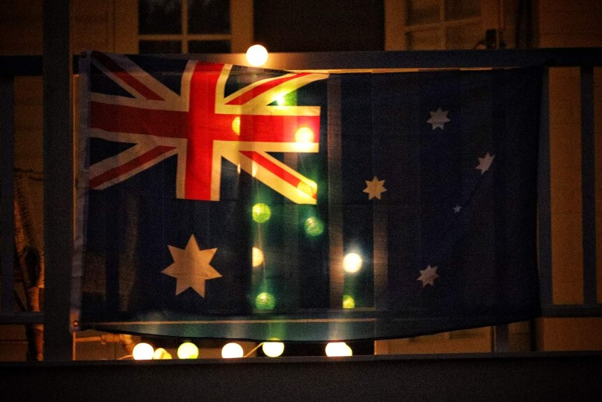 An Australian flag lit up to remember Anzac Day