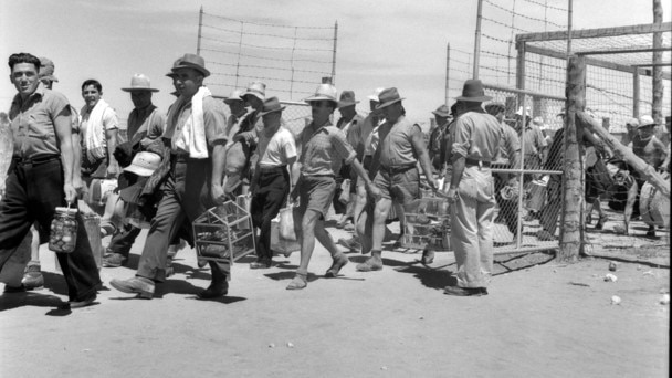 interned men walking out of prison gates