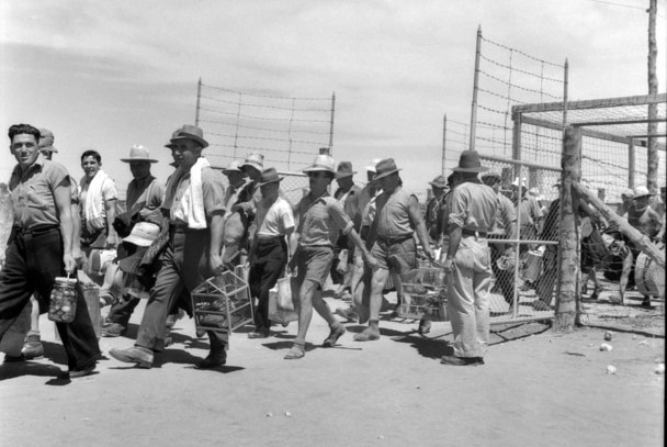 interned men walking out of prison gates