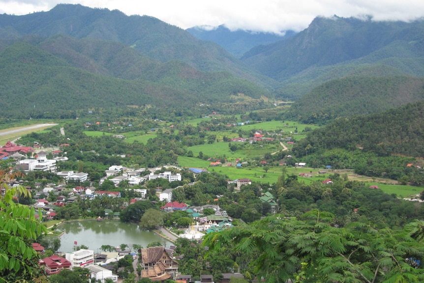 A bird's eye view of a town and surrounding hills in Mae Hong Son province.