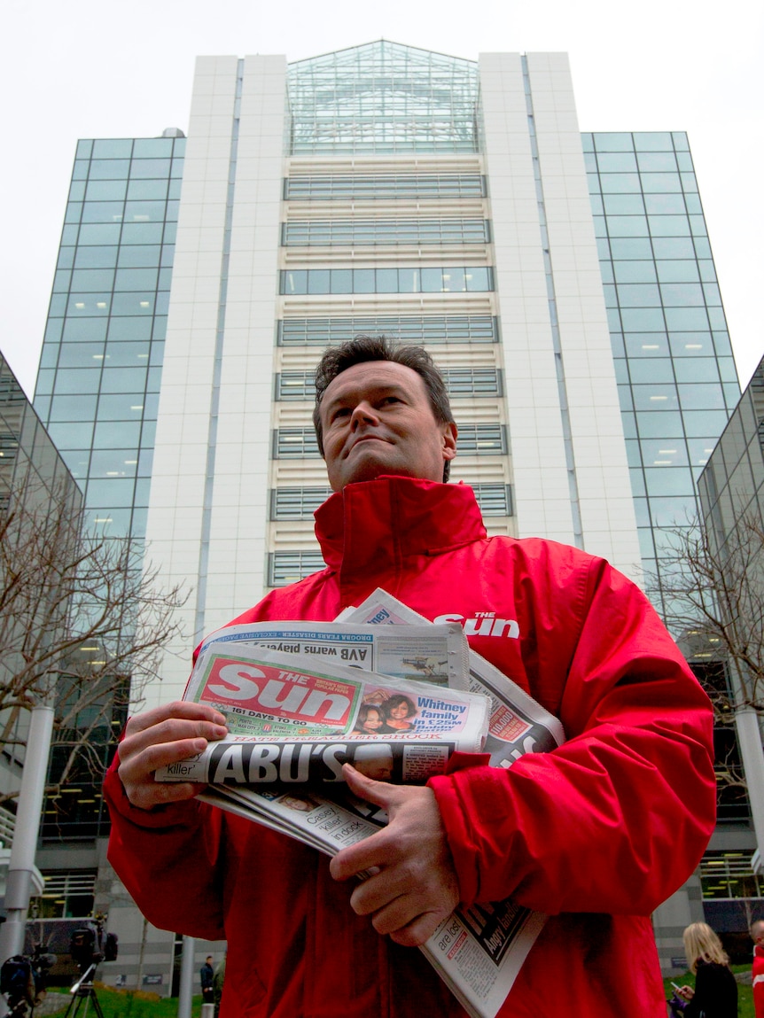 A Sun newspaper seller. (Reuters: Olivia Harris)