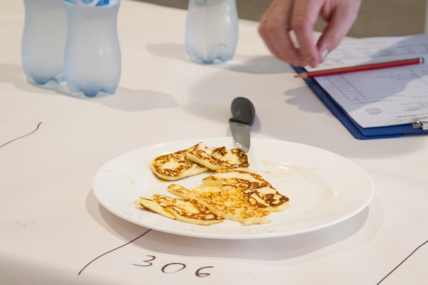 Cooked camel haloumi on a plate for judges to test.