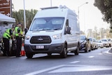 Motorists queue at a police checkpoint on the Queensland-NSW border on the Gold Coast.