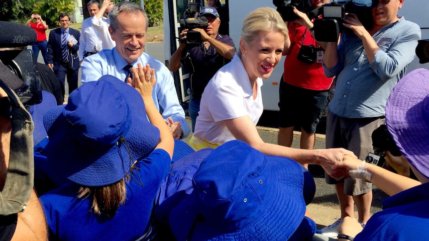 Bill Shorten and Chloe shake hands with school children.