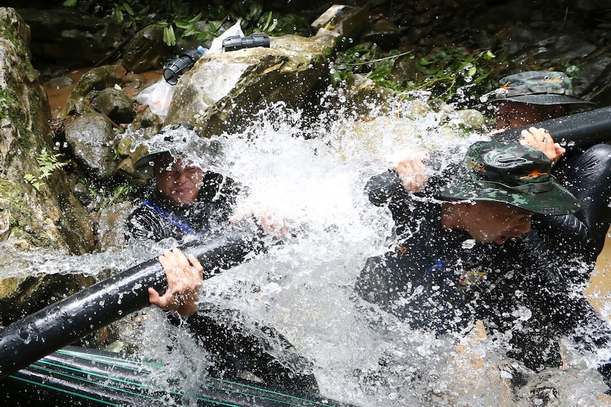 Thai soldiers battle with pipes during cave rescue