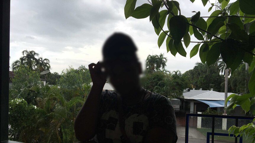 A dark silhouette of Maria (not her real name), who went to Balunu camp at age 13.