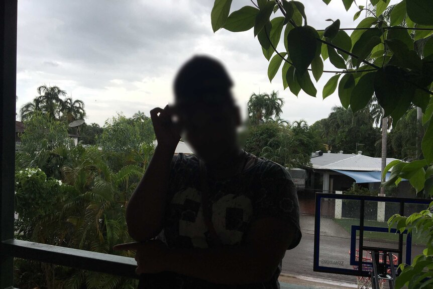 A dark silhouette of Maria (not her real name), who went to Balunu camp at age 13.