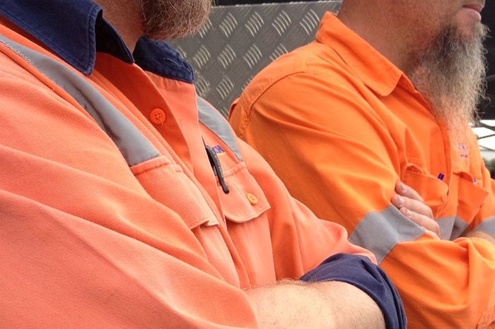 Two men in Hi-Vis jackets, faces not visible.