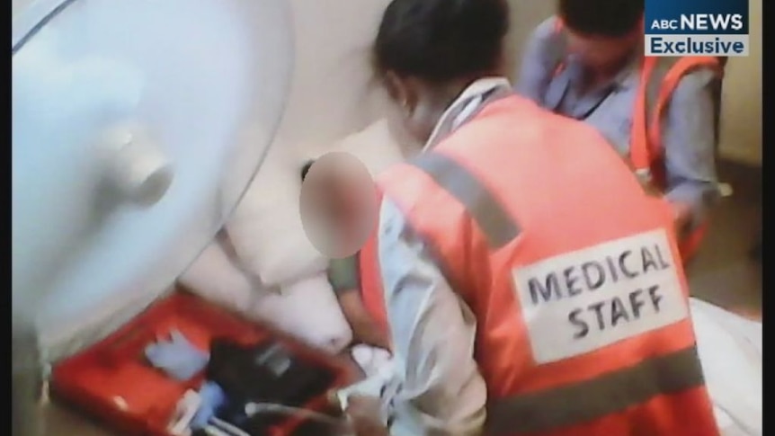 Mobile phone footage shows a detainee being treated by medical staff after sewing his lips together.