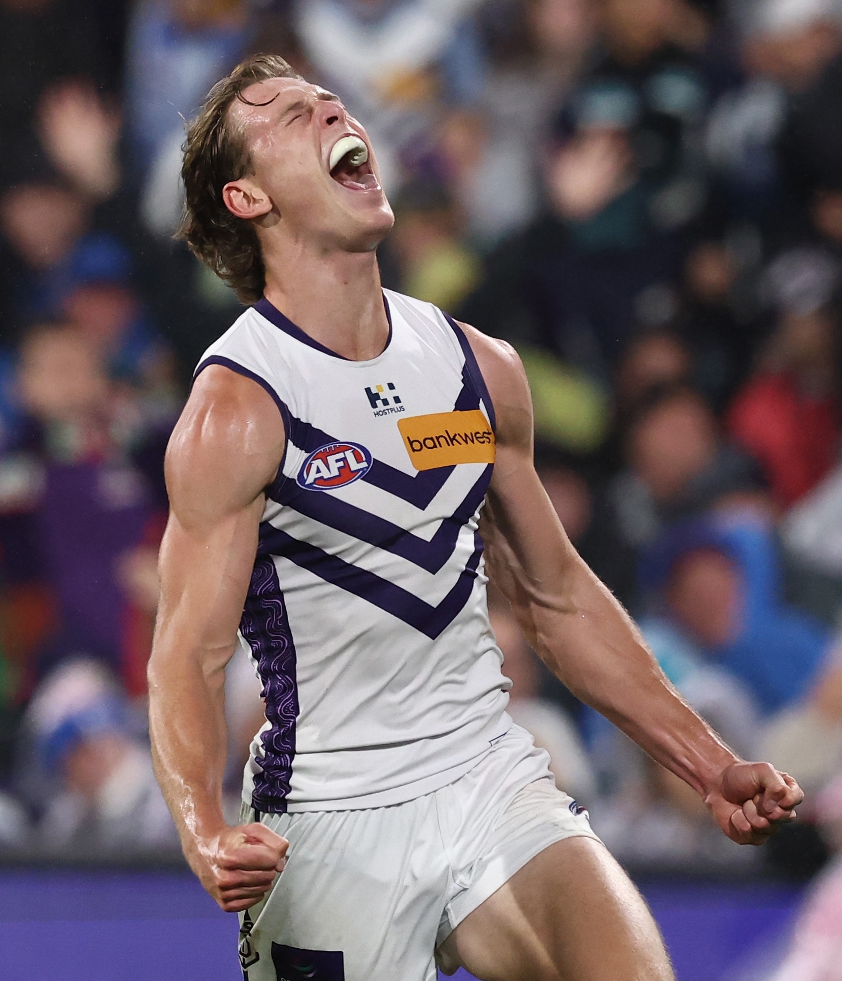 Matthew Johnson celebrates a goal for the Dockers against the Magpies.