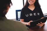 A smiling employee at one of Uber's greenlight hubs.