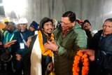 Chief Minister of the state of Uttarakhand, greeting a worker rescued.