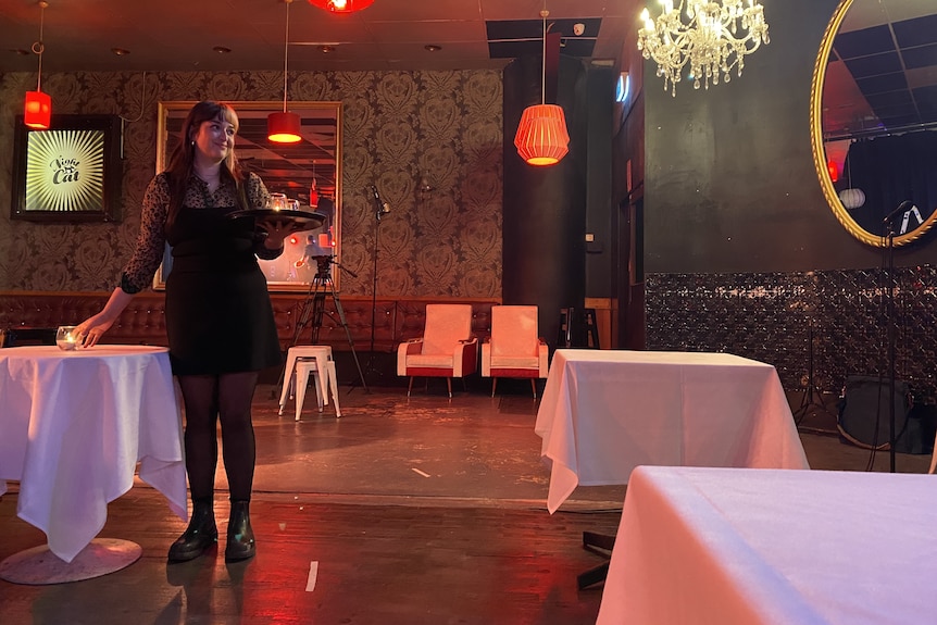 A waitress with a tray in the Nightcat jazz club