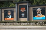 A sign showing India's Prime Minster (right) and a photo sign of PNG's PM (left).